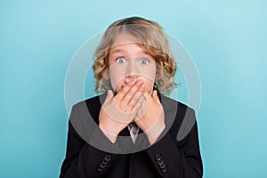 Photo of voiceless small blond boy close mouth wear uniform  on blue color background photo