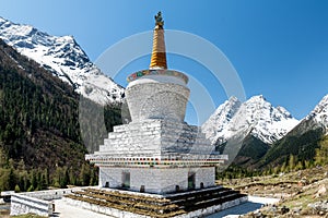 The white pagoda and snow mountains  in Four Girls Mountain scenic spot