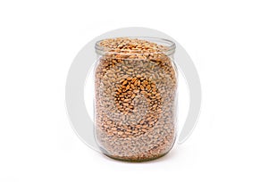 Photo wheat grains in a jar isolated on white.