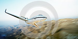 Photo of white modern and luxury generic design private jet flying in blue sky over earth.Uninhabited desert mountains