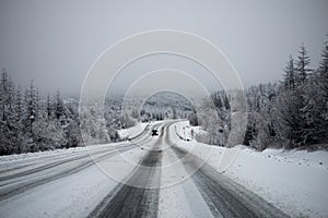 Photo of the winter road during the snowfall in Magadan, Russia