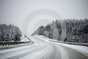 Photo of the winter road during the snowfall in Magadan, Russia