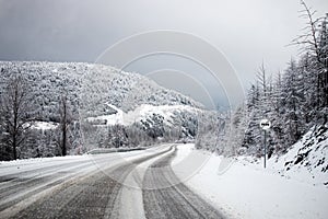 Photo of the winter road during the snowfall in Magadan, Russia