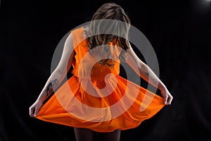 Photo woman with head down, orange dress