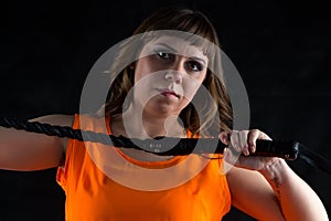 Photo of woman in orange dress with whip