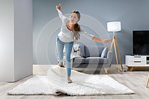 Woman Legs Stumbling With A Carpet photo