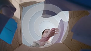 Photo of woman throwing teared paper, bottom view