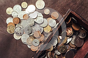 Photo of a wooden box filled with coins