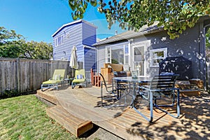 Photo of wooden deck with outdoor furniture