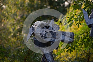 Photo of wooden dog heads in the background of the forest