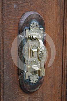 Wooden door handle with interesting golden detail on it