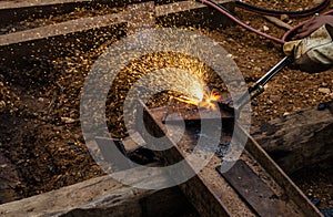 Photo of worker doing gas cutting on steel