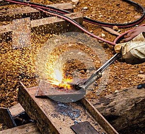 Photo of worker doing gas cutting on steel