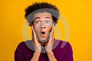 Photo of worried nervous guy open mouth two arms touch cheeks panic stupor reaction isolated on yellow color background