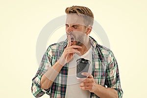 photo of yawning caucasian man with coffee. caucasian man with coffee isolated on white.