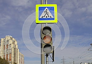 Photo of yellow traffic signal and pedestrian crossing sign.