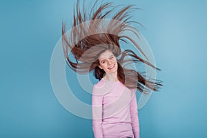 Photo of youg beautiful girl wind blowing hair healthy condition lotion isolated blue color background