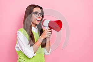 Photo of young activist happy screaming loud bullhorn announcement look curious empty space new advert isolated on