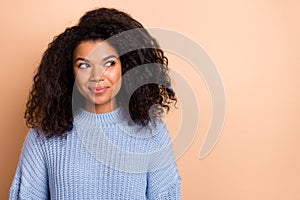 Photo of young adorable lady curious look empty space minded dream isolated over beige color background