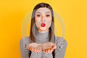 Photo of young adorable woman pouted lips send air kiss you coquettish flirty isolated over yellow color background
