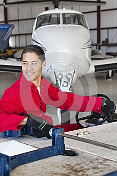 Portrait of young aeronautic engineer standing in front of an airplane propeller photo