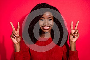 Photo of young african girl happy positive smile show peace cool v-sign isolated over red color background