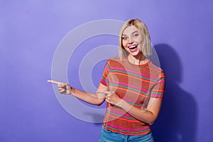 Photo of young amazed happy girl pointing fingers showing new design logo shutterstock marketplace isolated on purple