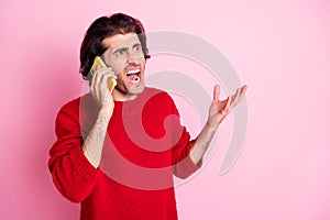 Photo of young arabian man call talk smartphone angry mad scream shout look empty space isolated over pink color