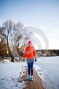 Photo of young athlete girl on morning exercise in winter