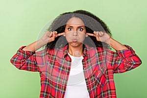 Photo of young attractive african woman fool cover fingers ears hold breath isolated over green color background