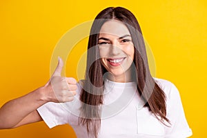 Photo of young attractive cheerful woman show thumb-up ad promo approve isolated over yellow color background