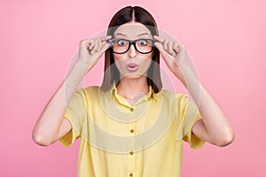 Photo of young attractive girl amazed shocked wear glasses vison ophthalmology isolated over pink color background