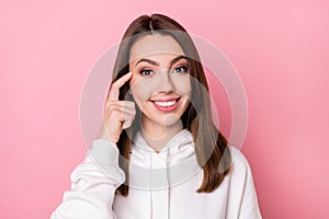 Photo of young attractive girl happy positive smile finger touch head accuse stupid isolated over pink color background