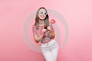 Photo of young attractive girl happy positive smile hold cookies stick heart figure isolated over pastel color