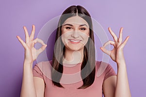 Photo of young attractive girl happy positive smile show okay deal done sign isolated over violet color background