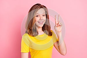 Photo of young attractive girl happy positive smile show peace cool v-sign isolated over pink color background