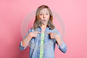 Photo of young attractive girl point fingers herself amazed shocked blaming  over pink color background