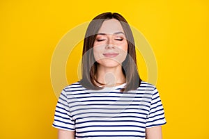 Photo of young attractive gorgeous girl wear striped blue t-shirt dreaming thinking about vacation isolated on yellow