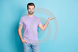 Photo of young attractive man hold hand demonstrate present product advert isolated over blue color background