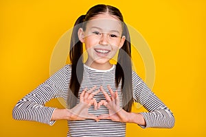 Photo of young attractive school girl show fingers heart symbol love romantic  over yellow color background