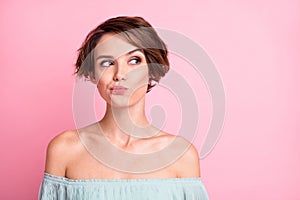 Photo of young attractive woman unhappy upset uncertain hesitate doubt look empty space isolated over pink color photo