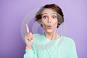 Photo of young beautiful charming lovely shocked surprised girl pointing finger copyspace isolated on violet color