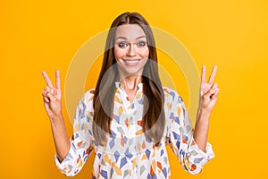 Photo of young beautiful girl happy positive smile show v-sign peace cool isolated over yellow color background