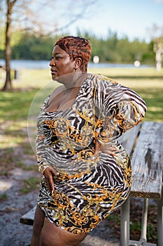 Photo of a young beautiful plus size model posing outdoors in nature