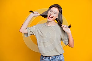 Photo of young beautiful pretty happy positive smiling crazy girl dancing pull hair isolated on yellow color background