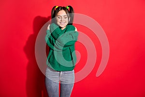 Photo of young beautiful smiling cheerful positive female hug embrace herself isolated on red color background