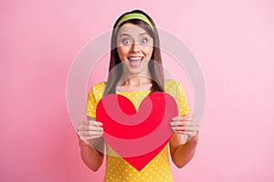 Photo of young beautiful smiling ecstatic positive girl hold present big red heart isolated on pink color background