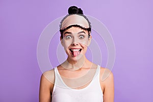 Photo of young beautiful smiling funky funny girl showing tongue fooling around isolated on violet color background
