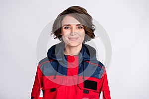 Photo of young beautiful smiling lovely girl assistant paramedic wearing red uniform isolated on grey color background