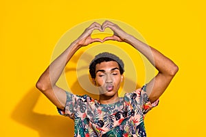 Photo of young boyfriend in stylish t shirt make heart gesture pouted lips romantic flirt kisses  on yellow